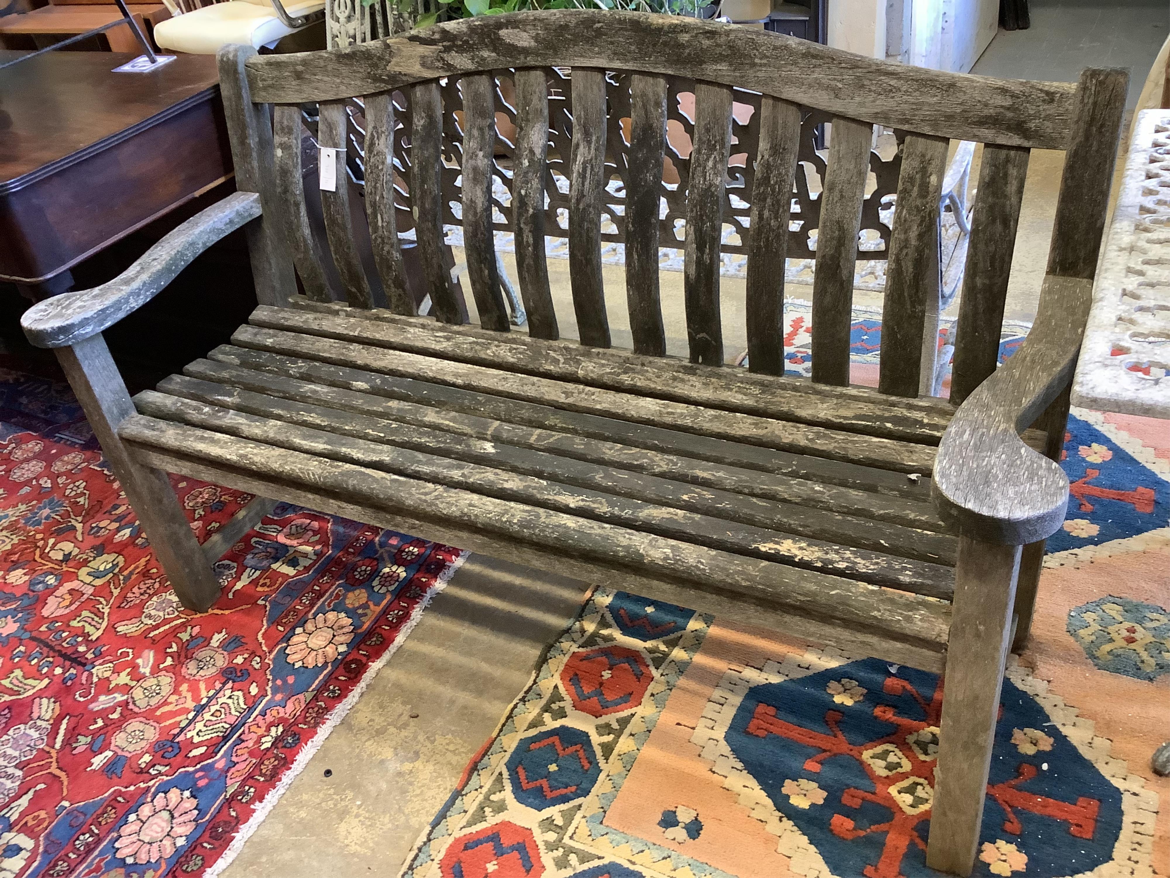 A weathered teak garden bench, length 155cm, depth 57cm, height 98cm